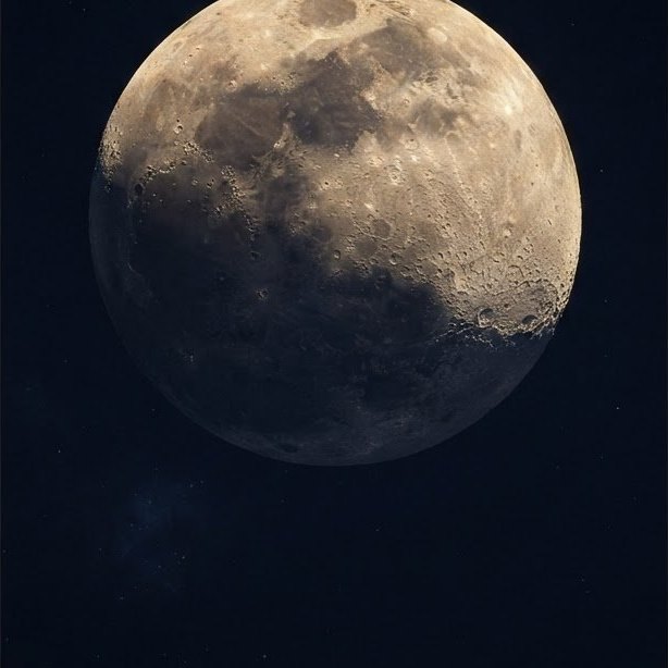 A waxing gibbous moon with sharp crater detail along the terminator